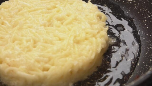 Close-up panorama of the fried potato pancake on the frying pan