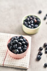  Delicious group of blueberries on ceramic bowls marble surface