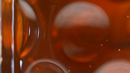 Foamy beer in glass close-up. Alcohol golden beer drink in mug. Slow Motion Shot of Pouring Fresh Beer into Glass on White Background