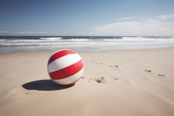 A colorful beach ball resting on a sandy beach
