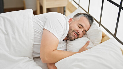 Grey-haired man lying on bed sleeping at bedroom