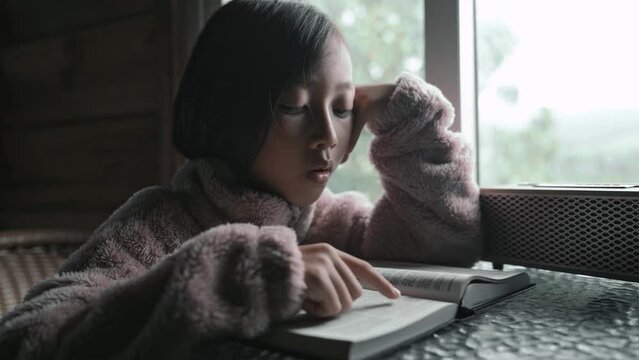 Child girl reading bible study and learn spiritually, Christian youth concept. High quality 4k video.