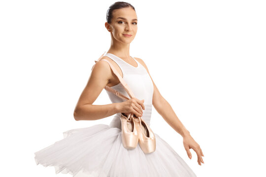Ballet dancer holding her toe shoes and smiling