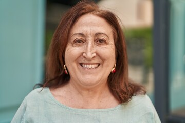 Senior woman smiling confident standing at street