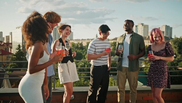 Carefree Men And Women Gathering On Rooftop For Summer Party