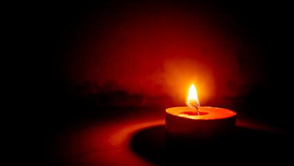 small round scented candle with a glass of vodka