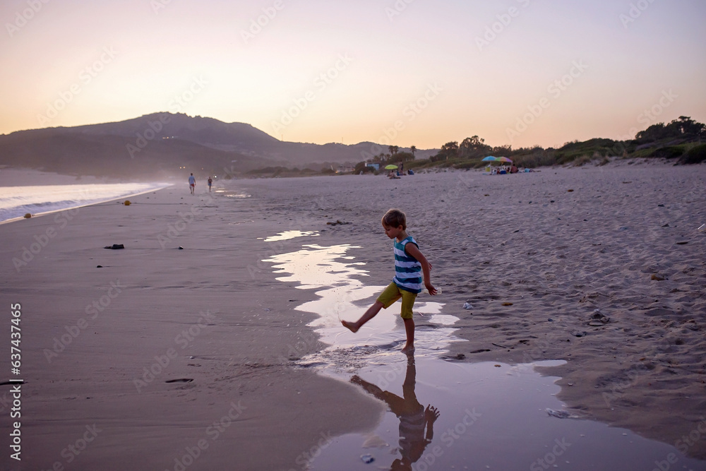 Canvas Prints Happy children, playing on the beach on sunset, kids running in the water in the ocean