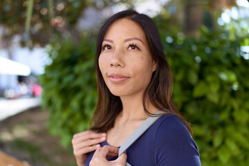 Young asian woman smiling confident looking to the side at park