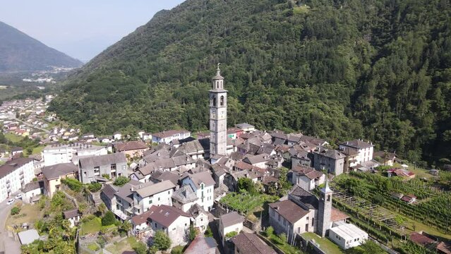 4K drone video, circling around beautiful church in a village in the mountains of the canton of tessin in switzerland