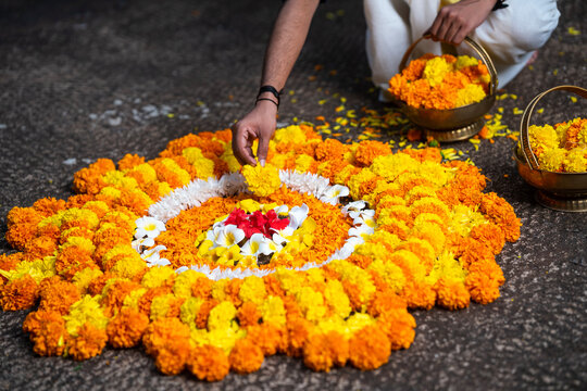 Person making Onam flower decoration, Kerala traditional festival Onam Pookalam background