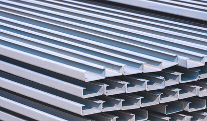 Stack of many gray rust proof C light lip channel steel material in construction site area