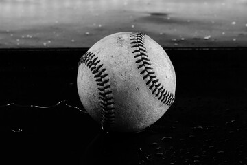 Used baseball closeup with water for rain game concept.
