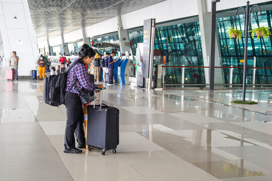 Indonesia Jakarta, 10 August 2023 Woman Walks With Luggage At Soekarno Hatta Airport Terminal, Carrying Suitcases When Going To Flight Departure Gate for traveling