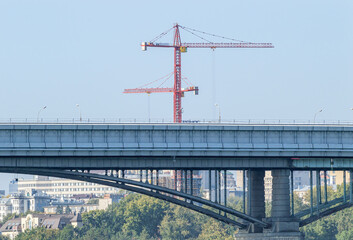 Metro Bridge on the Background of the City and Construction Cranes