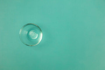 Minimalist Still Life and Clean of Empty Transparent Glass Bowl on Green Background with Copy Space