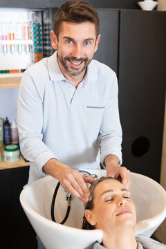 beautiful woman sitting in a beauty salon with hairdresser