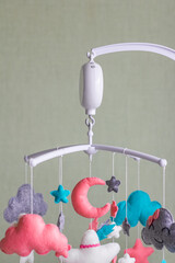Baby crib mobile. Toys above the baby crib. Hanging soft clouds, stars and moon for the child
