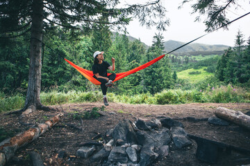 happy woman on hammock mountains on background