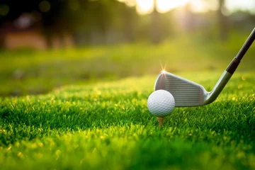 Fotobehang Golf ball close up on tee grass on blurred beautiful landscape of golf background. Concept international sport that rely on precision skills for health relaxation. © Sittipol 