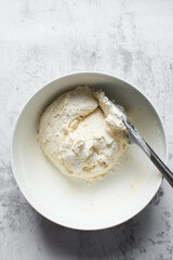 Vanilla muffin batter in a mixing bowl, process of making cupcakes and muffins, folded batter