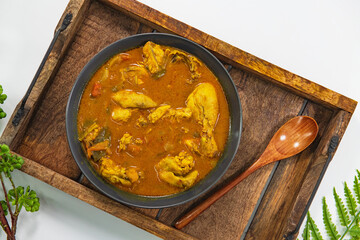 Chicken curry or masala or country chicken kuzhambu Tamilnadu style , chicken curry using fried coconut oil in traditional way and decorated in white bowl. Main dish for rice, chapati and paratha...