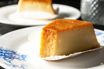 pudim or pudding, two slices of pudding on a white plate, delicious gourmet. also known as flan