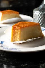 pudim or pudding slice. also known as flan. vertical shot of two slices of pudding
