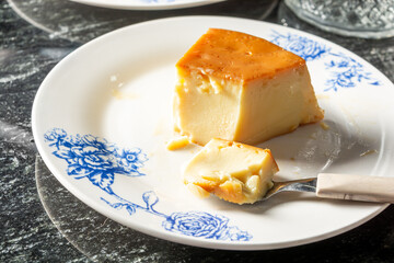 pudim or pudding and a spoon, gourmet homemade dessert. traditional brazilian food known also as flan
