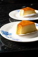 pudim or pudding slice. also known as flan. vertical shot of two slices of pudding