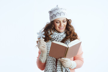 smiling modern woman in sweater, mittens, hat and scarf