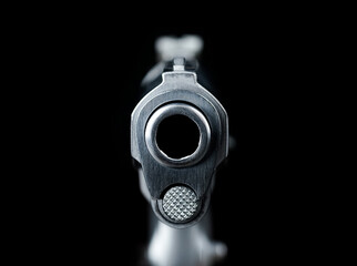 The muzzle part of the pistol scene Pointed Directly at Viewer on a black background represents a...