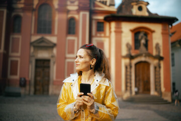 surprised woman in blouse in Prague Czech Republic using phone