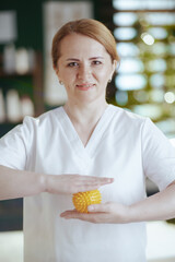 female medical massage therapist in spa salon with massage ball
