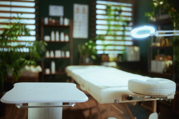 massage table and table on wheels in modern spa salon