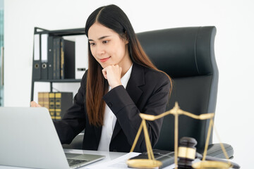 Justice and law concept. smiling Female lawyer in office with the gavel working with digital tablet computer docking keyboard on white table.