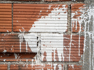 White paint on a brick wall, graffiti support, space for a text, virgin wall for a street art.