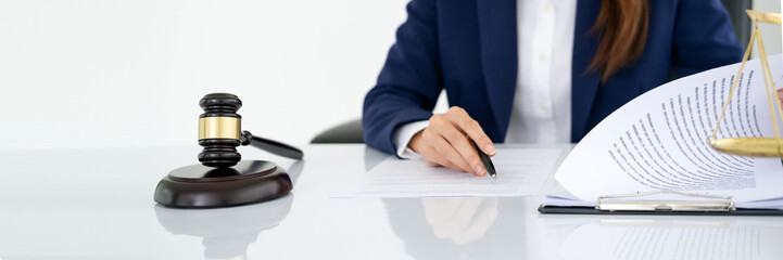 Lawyer working or drafting legal document at law firm office desk. Gavel hammer for righteous and equality judgment by lawmaker and attorney. Equilibrium