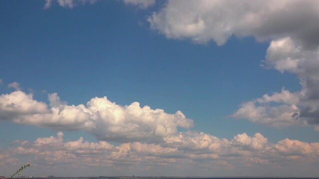Slow motion, white cumulus clouds moving quickly across the sky over the Black Sea