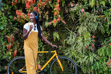 Young woman with bicycle taking a walk in the city while eating ice cream. Concept: lifestyle,...