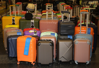 Sale of multi-colored bright plastic suitcases of different sizes in the Urbanica store. pink,...