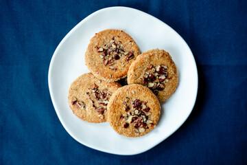 White plate with walnut cookies - top view