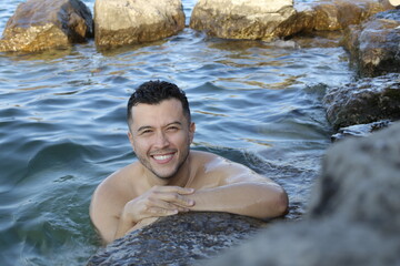 Fototapeta na wymiar Handsome ethnic man in the water