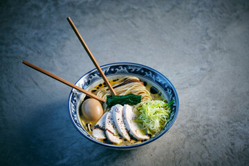 Delicious ramen with chicken fillet slices and boiled egg