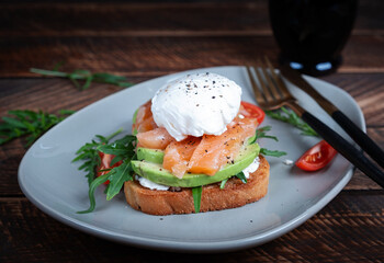 Breakfast toast. Toast with avocado, salmon and poached egg. Keto diet