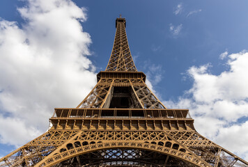 Eiffel tower Paris France looking up view clouds blue sky