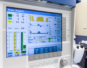 Hospital monitor displays vital signs: heart rate, blood pressure, and more. Symbolizes patient...