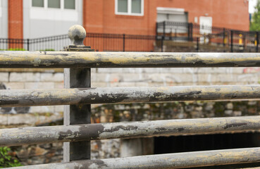 Metal fence: Symbol of boundaries and security; conveys separation and protection. Metaphor for division and safeguarding spaces. Stark, functional