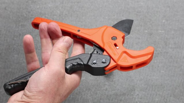 Cutter for plastic pipes cuts high density polyethylene water pipe.