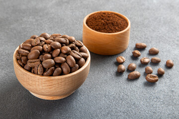 Coffee beans with a bowl of ground coffee ,closeup