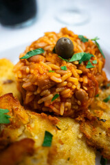 Capture the essence of Alentejo with a classic Portuguese delight: crispy cod fritters served with flavorful tomato rice. A taste of tradition!